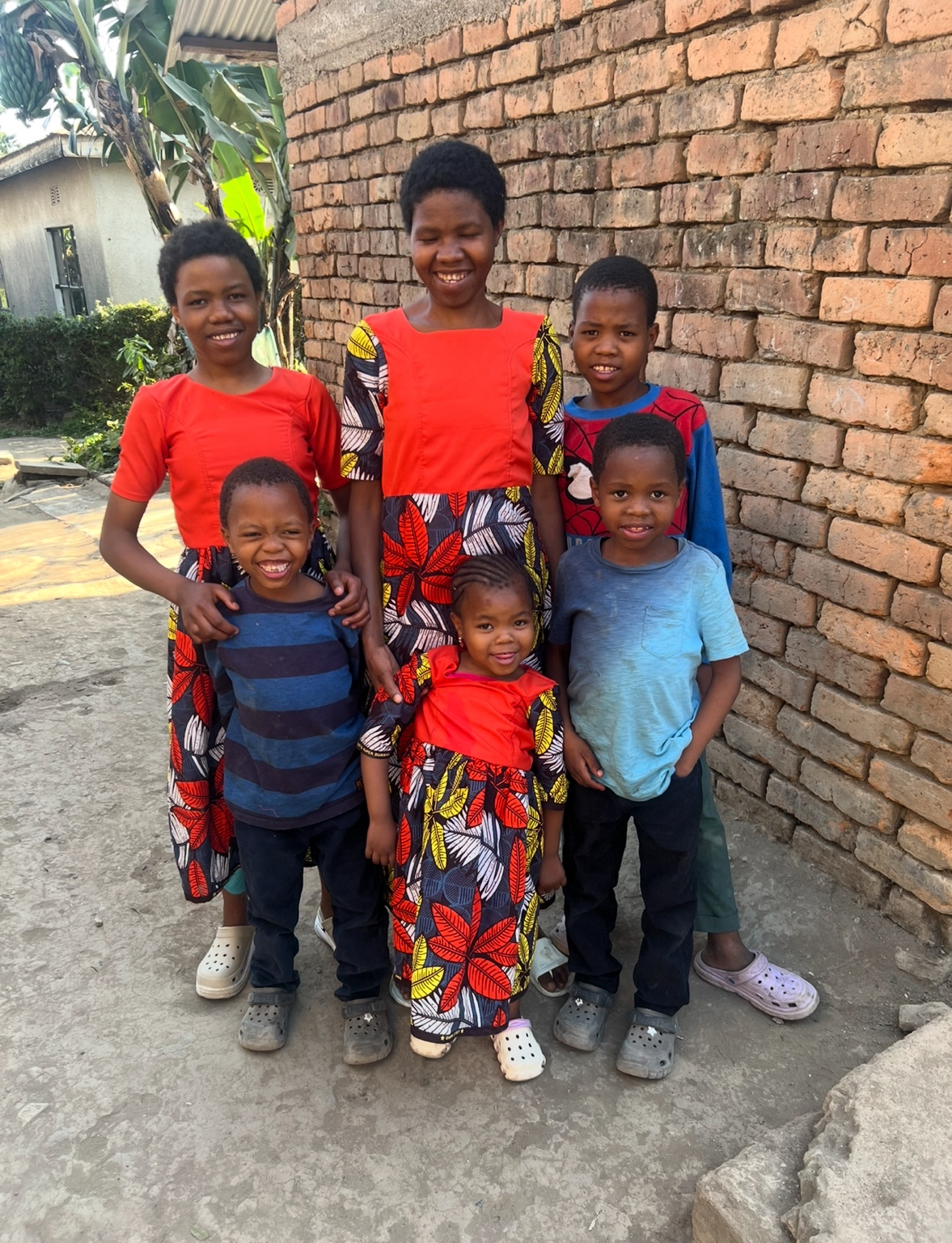 A family group photographed together outside their home.
